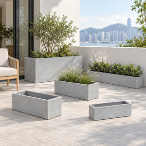 Five rectangular cement planters in a terrace setting with a chair for scale