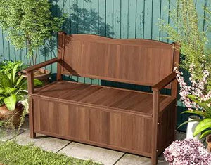 a wooden bench sitting in the middle of a garden