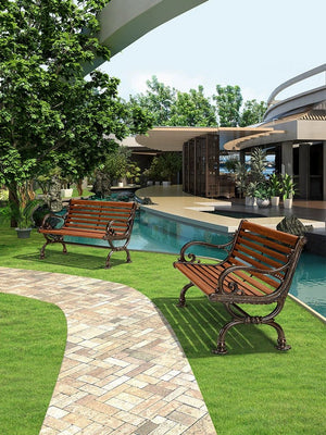 a couple of benches sitting on top of a lush green field