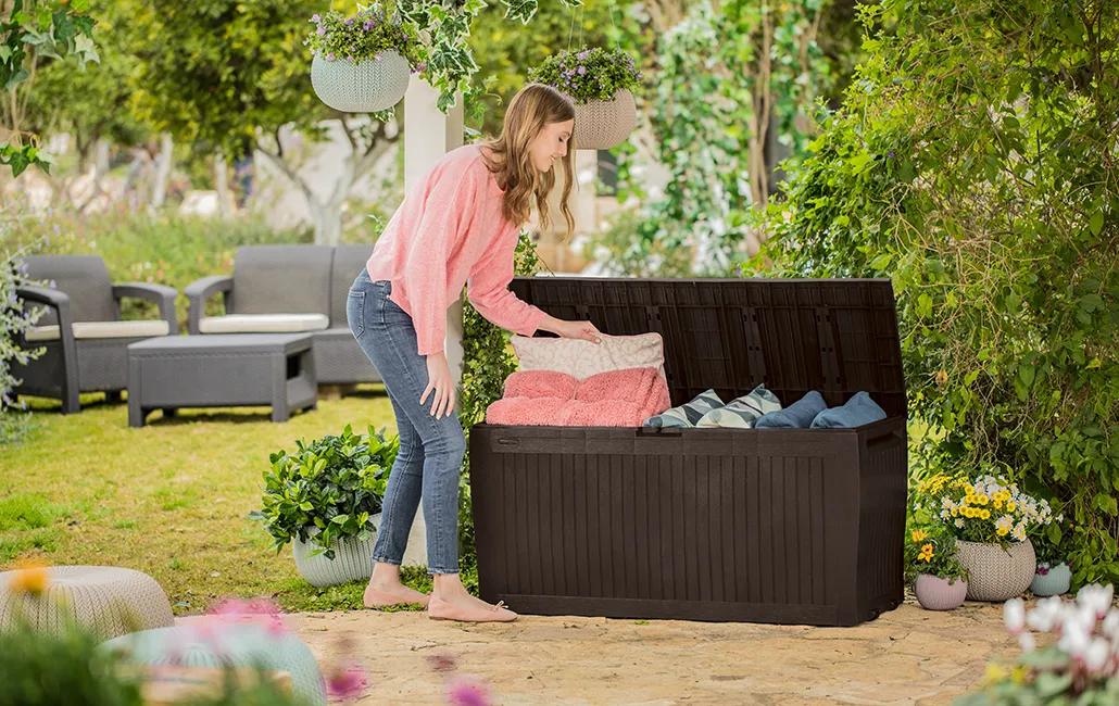 Keter Comfy 270 L storage box holding cushions on a garden patio