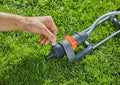 a man is trimming the grass with a lawnmower