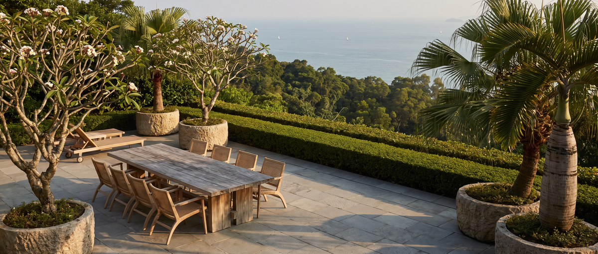 Teak outdoor dining table on a private garden terrace overlooking the sea, Hong Kong