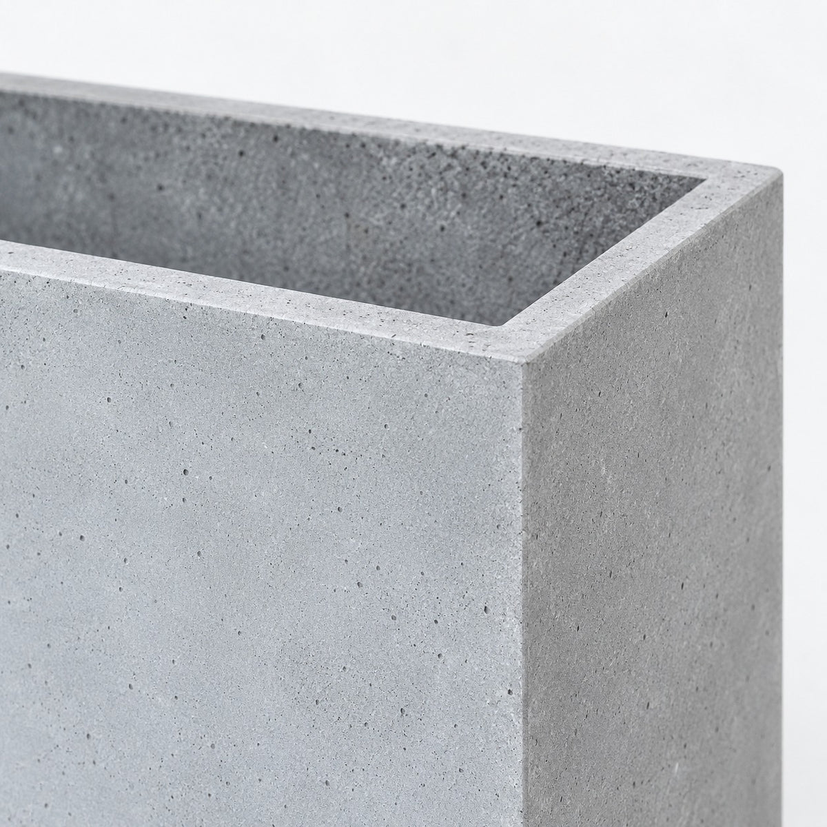 Rectangular planter corner, flat rim and grey cement surface detail
