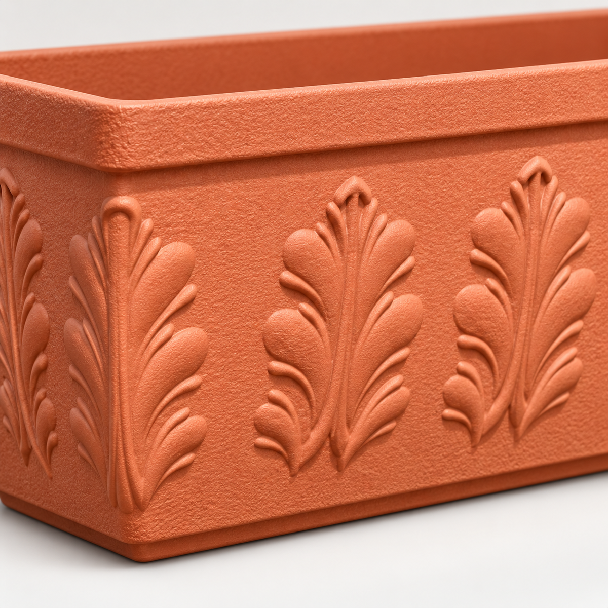 Close-up of raised floral relief on brick-red PRM planter