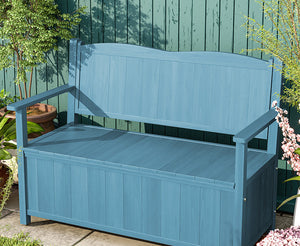 a blue bench sitting next to a green wall