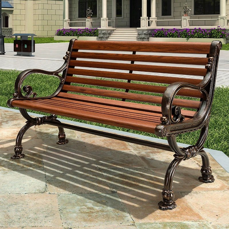 a wooden bench sitting on top of a stone walkway