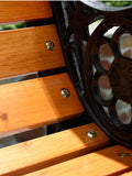 a close up of a wooden bench with holes in it
