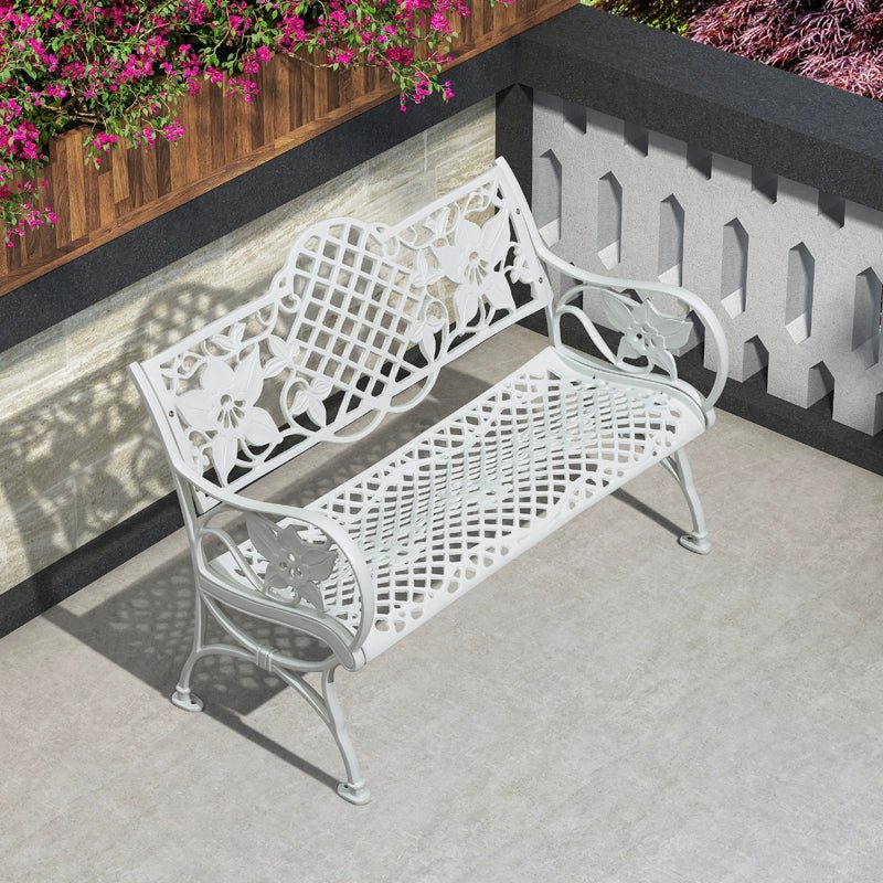 a white bench sitting on top of a cement floor