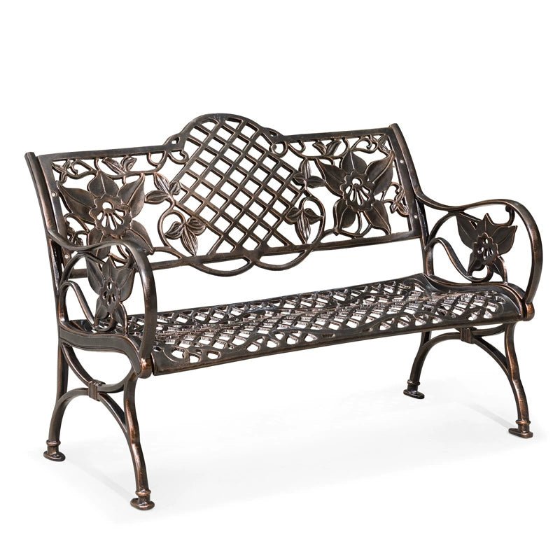 a wrought iron bench with flowers on it
