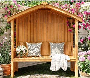a wooden bench sitting in the middle of a garden