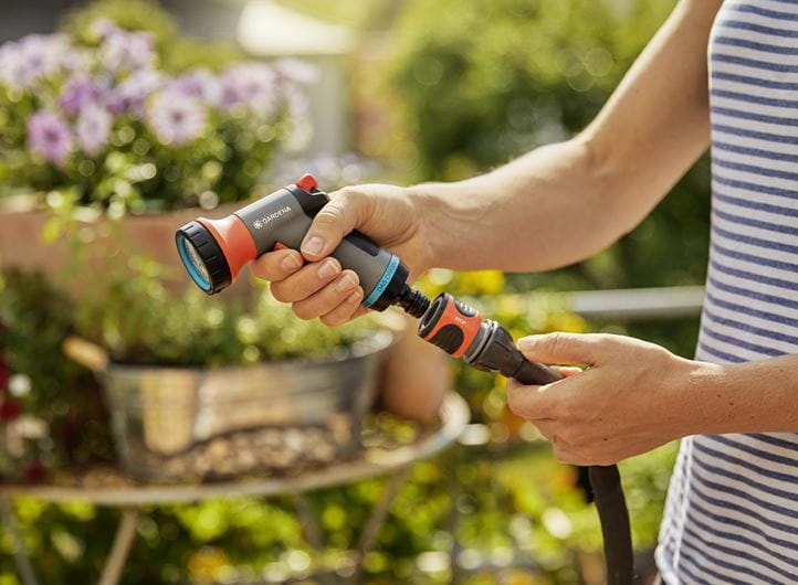 a person holding a garden tool in their hand