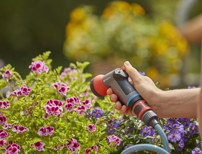 a person using a power drill to trim a plant